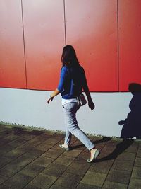 Full length of woman standing by railing