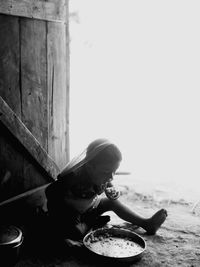 Boy sitting on table at beach