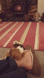 Low section of woman lying down at home