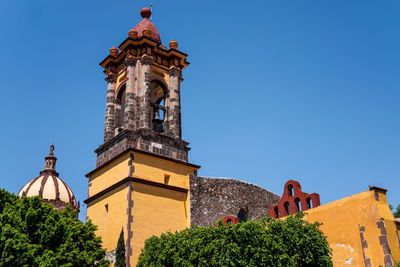 Low angle view of building against clear blue sky