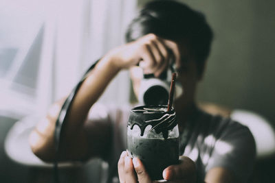 Midsection of man holding drink