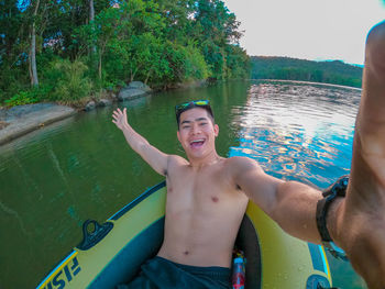 Portrait of happy young man in lake