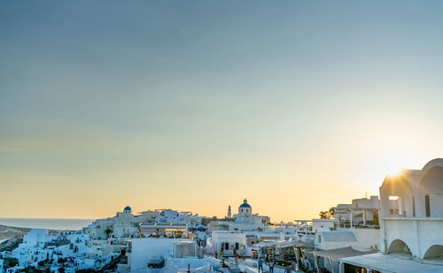 Panoramic view of oia town in santorini island with old whitewashed houses and traditional windmill, 