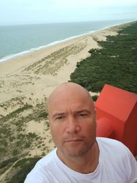 Portrait of man on beach against sky