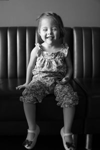 Portrait of young woman standing on tiled floor