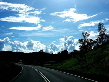 Road passing through landscape against sky