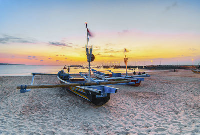 Boats in sea against sky during sunset