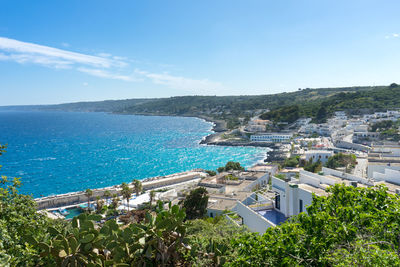 High angle view of sea and buildings against sky