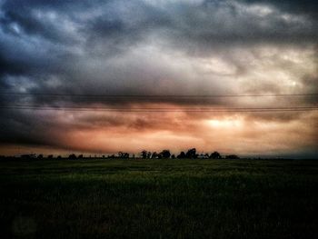 Scenic view of field against cloudy sky