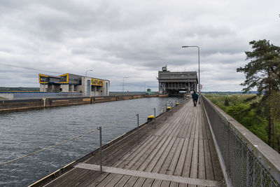 Pier over lake against sky