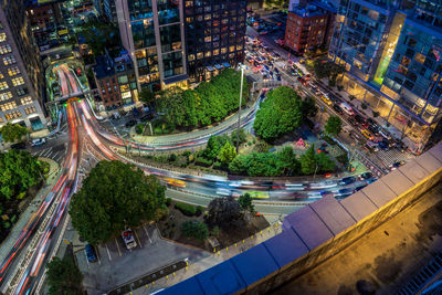 High angle view of illuminated street amidst buildings in city