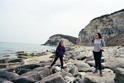 Two women standing on the seaside