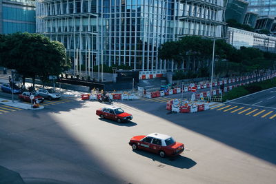 High angle view of taxis on road against building on sunny day in city