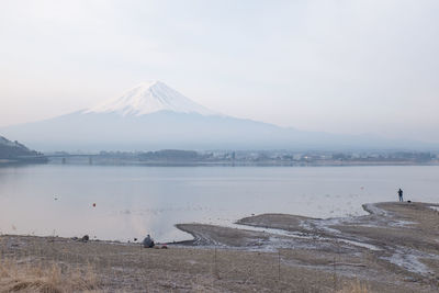 Calm lake against mountain peak