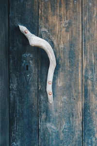 Close-up of handle on wooden door