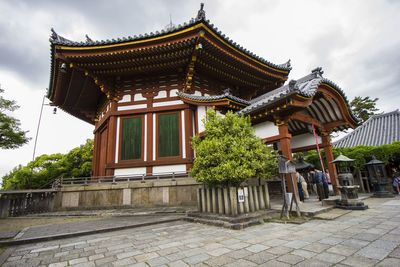 Temple outside building against sky