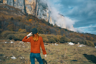 Rear view of person standing on mountain