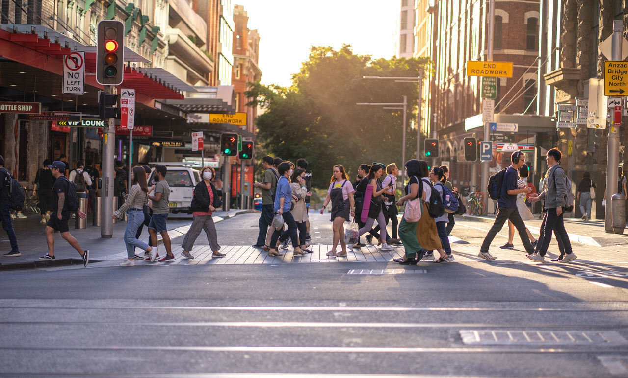 PEOPLE CROSSING ROAD IN CITY