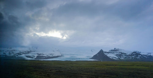 Scenic view of snowcapped mountains against sky