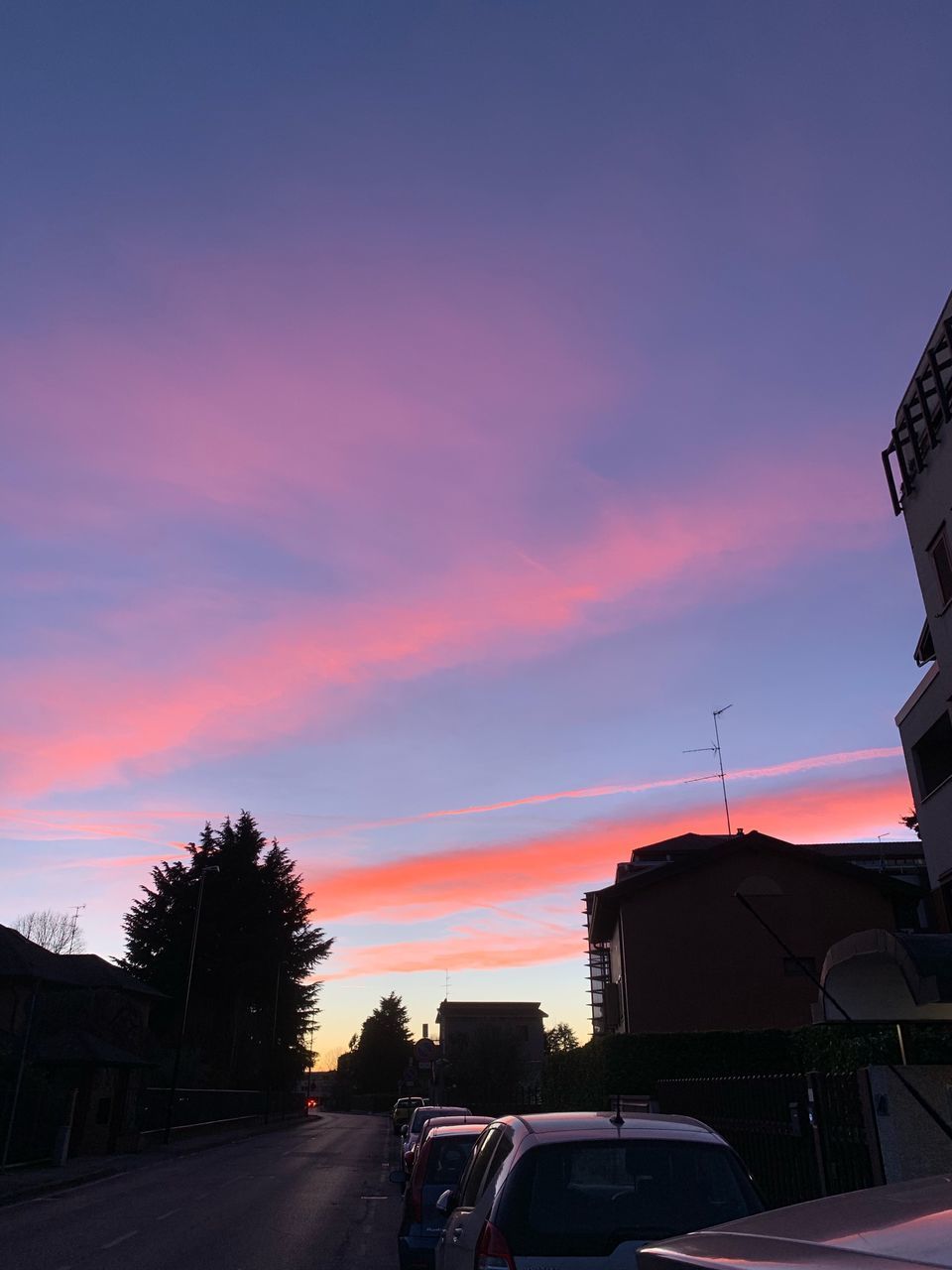 CARS ON STREET AGAINST SKY AT SUNSET