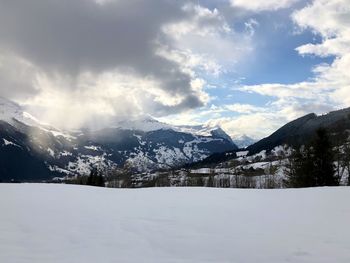 Scenic view of snowcapped mountains against sky