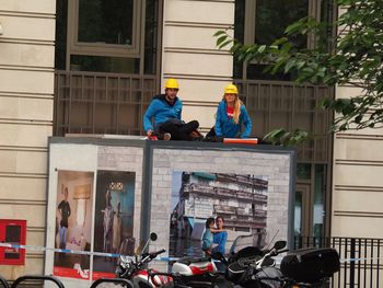 People working in front of building