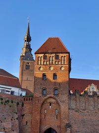 Low angle view of old building against blue sky