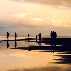 People on beach at sunset