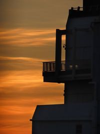 Low angle view of building against sky during sunset