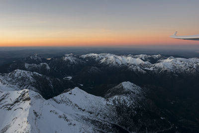 Scenic view of snow mountains against sky during sunset