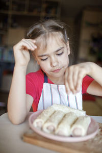 Girl holding sweet food at home