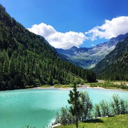 Scenic view of lake and mountains against sky