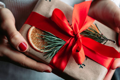 Cropped hand of woman holding gift
