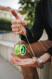 Midsection of man playing with yo-yo