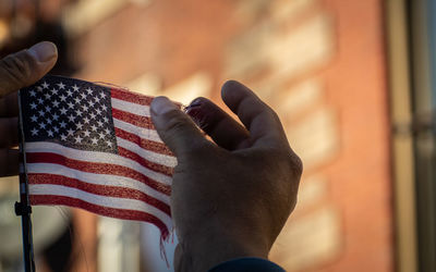 Close-up of hand holding american flag