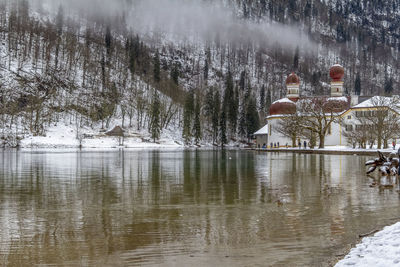 Reflection of trees in lake during winter