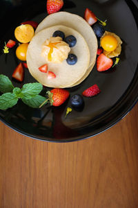 High angle view of fruits in plate on table