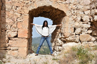 Woman standing against wall