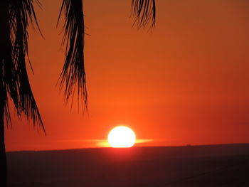 Scenic view of sea against orange sky