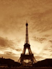 Low angle view of eiffel tower against cloudy sky