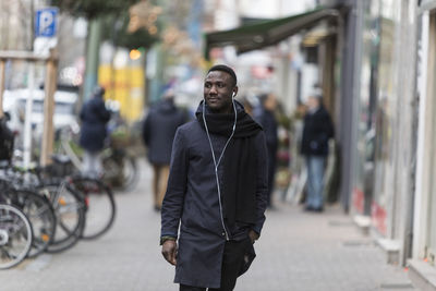 Man standing on street in city