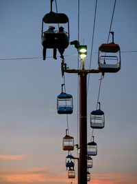 Overhead cable cars against clear sky