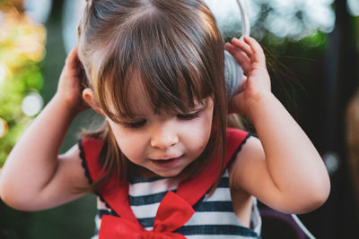Cute girl listening music outdoors