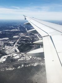 Aerial view of airplane wing over landscape