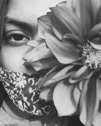 Close-up portrait of woman with pink flower