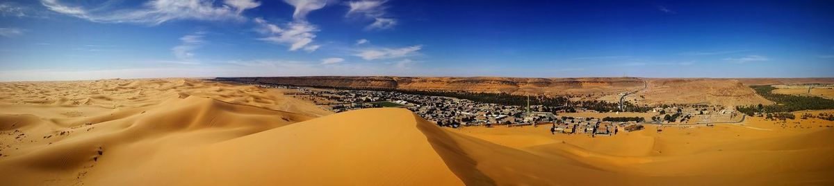 Panoramic view of desert against sky