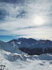 Scenic view of snowcapped mountains against sky