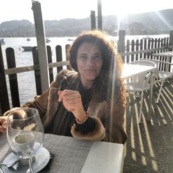 Portrait of smiling woman sitting on table