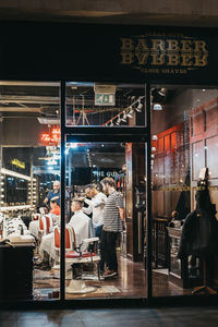 People in illuminated city at night