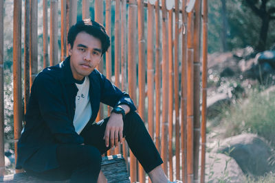 Portrait of young man sitting outdoors